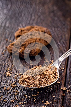 Spoon with grated and dark chocolate, chocolate powder used as a filling for sweets. American homemade chocolate chip cookies in