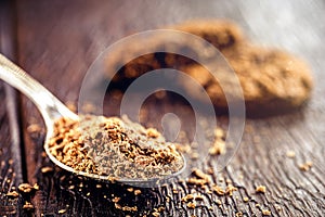 Spoon with grated and dark chocolate, chocolate powder used as a filling for sweets. American homemade chocolate chip cookies in