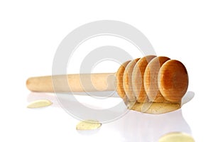 Spoon with honey lies on a white background