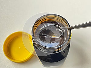 Spoon in jar of Yeast extract marmite jar from above