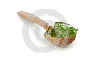 Spoon with kiwi jelly isolated on white background