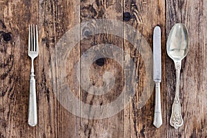 Spoon knife and fork on the wooden board.