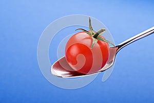 Spoon with little tomato