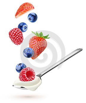 Spoon with natural yogurt and falling berries isolated on white background
