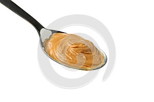 Spoon with peanut butter isolated on white background