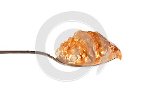 Spoon of peanut butter on white background