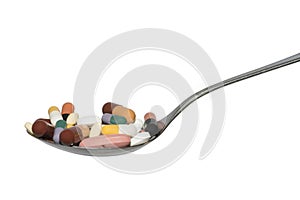 Spoon With Pills Capsules And Tablets Isolated On White