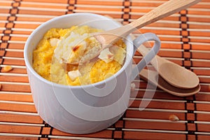 Spoon of polenta baked with cheese