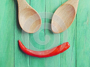 Spoon and Red chili peppers in smile