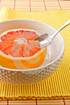 Spoon sectioning ruby red grapefruit