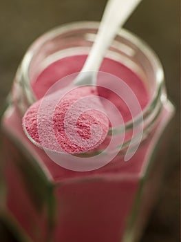 Spoon of Sel Rose on a Glass Jar