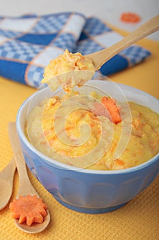 Spoon with semolina and carrots