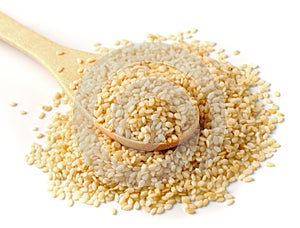 spoon with sesame seeds on a white background