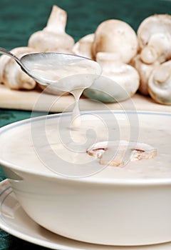 Spoon spilling mushroom soup