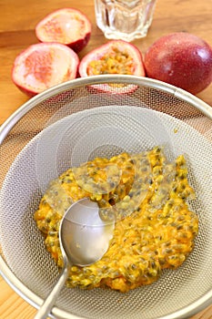 Spoon Squeezing Passion Fruit Pulps to Extract Liquid for Making Puree