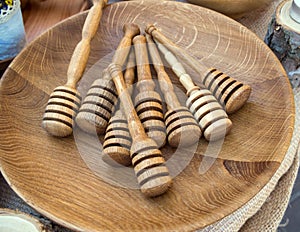 Spoon sticks for honey lie on a wooden dish