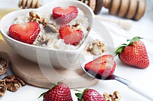 Spoon with strawberries, oatmeal and walnuts