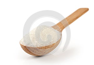 Spoon with sugar on a white background.