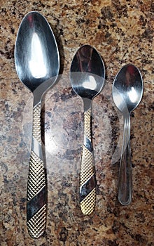 Spoon and teaspoons on kitchen table background