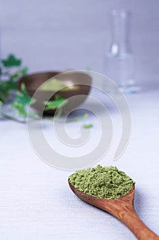 Spoonful of the ayurvedic powder Sidr Zizyphus jujuba on a light background