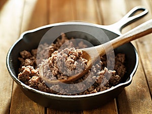 Spoonful of freshly cooked ground beef from iron skillet