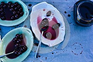 Spoonful of sour Morello cherries on vintage ceramic platter