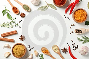 Spoons and bowls with different spices and ingredients on white background