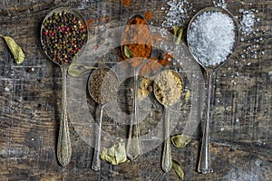 Spoons with colorful spices - closeup