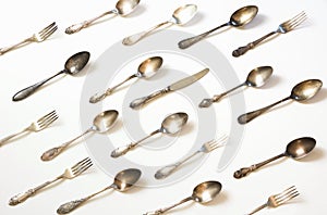 Spoons, forks, knives, silverware pattern on white background. Kitchen texture. Top view