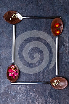 Spoons with frozen chocolate in the form of a square photo
