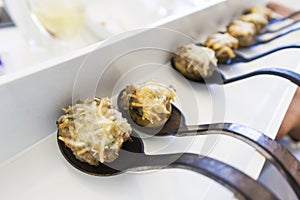 Spoons with mushrooms stuffed with gormet cheese