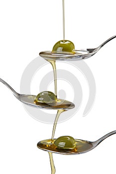 Spoons and olive oil falling