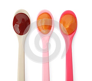 Spoons of tasty pureed baby food isolated on white, top view