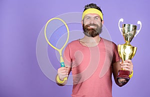 Sport achievement. Celebrate victory. Tennis champion. Athletic man hold tennis racket and golden goblet. Win tennis