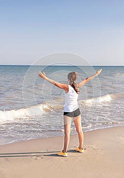 Sport active woman with raised up hands.