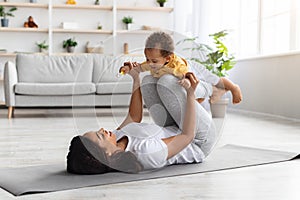 Sport Activities With Baby. Black Mom Exercising With Infant Son At Home
