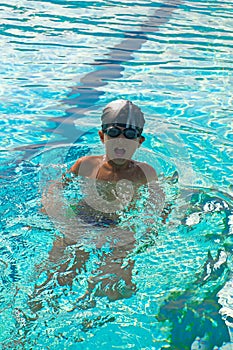 Sport activities on the pool, boy swimming in water, summertime