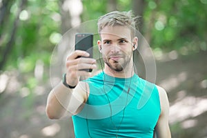 sport app on phone. digital sport. smart watch. athletic man in sportswear make selfie. outdoor workout. Fitness app. Ui