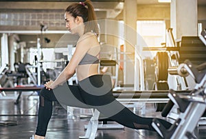 Sport asian woman stretching for warming up befor doing exercises cross fit body muscular training workout in gym