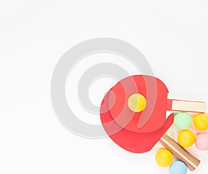 Sport background. Red ping-pong rackets and varicolored balls. Flat lay, top view.