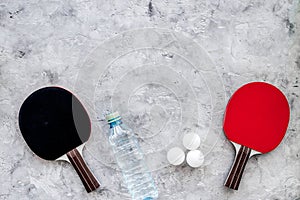 Sport background. Traning cocept. Ping pong racket and water on grey background top view copyspace