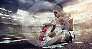 Sport backgrounds. Runner stretching on the the start line.