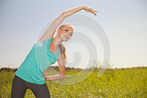 Sport beauty blond young woman exercising in the outdoors yoga