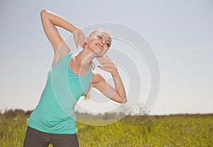 Sport blond young woman exercising in the outdoors yoga photo