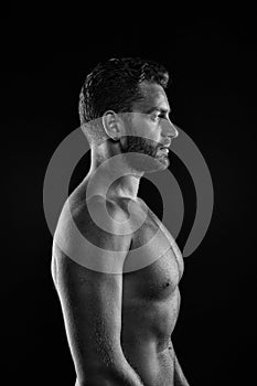 Sport bodybuilding and fitness concept. Bearded man athlete with fit torso in profile. Sportsman with muscular chest and belly. Bo