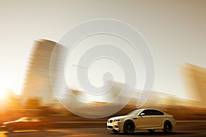 A sport car speeding in front of a skyline