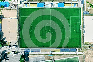 Sport center during training of the football team. players are playing a soccer match. aerial top view