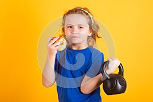 Sport child workout. Child exercising with kettlebell. Sporty child with dumbbell. Fit kids training.