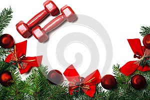 Sport Christmas and New Year background with red dumbbells, green branches fir tree red glass balls and red bows bells on white