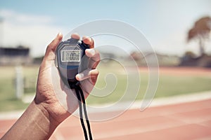 Sport, coach and closeup of hand with stopwatch for time, training and speed of athlete, runner or race. Mentor, trainer